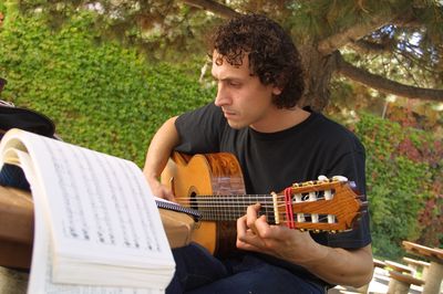Student playing the guitar on campus, 2003