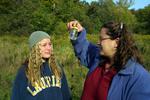 Two students examining water sample on field trip, 2003