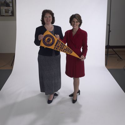 Staff members holding pennant Laurier Brantford, 2002