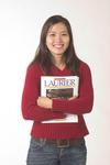 Student holding Laurier course package book, 2004