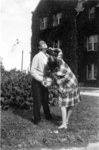 Woman shaving a man's face