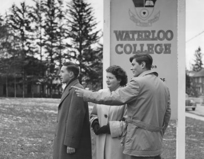 Three students in front of Waterloo College sign