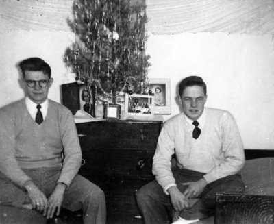 Two Waterloo College students in front of a Christmas tree