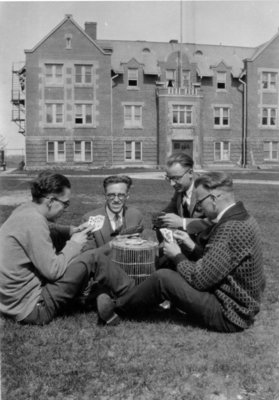 Waterloo College students playing a card game outside of Willison Hall