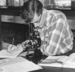 Waterloo College student using a microscope