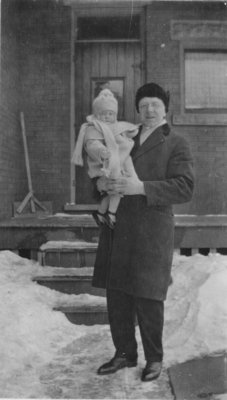 Pastor Carl Sorensen holding a child