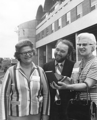 Helen Chapman, Jim Lawson, and Mary Heer holding bookend