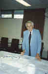 Erich Schultz cutting the cake at Wilfrid Laurier University Library's 30th anniversary