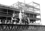 Waterloo Lutheran University cheerleader and construction workers on Central Teaching Building construction site