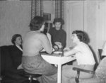 Four women playing a card game