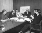 J. Ray Houser meeting with five men