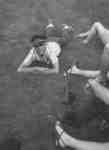 Male Waterloo Lutheran University student laying on grass