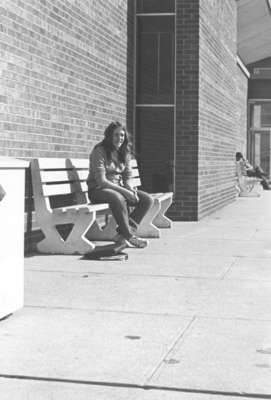 Woman sitting on a bench, Waterloo Lutheran University