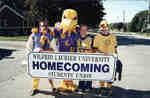 Three students and the Hawk mascot at Homecoming 2001, Wilfrid Laurier University