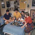 Four students playing board game in residence room, Wilfrid Laurier University