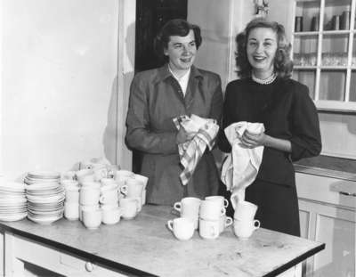 Two women drying dishes