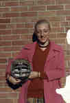 Woman holding football helmet