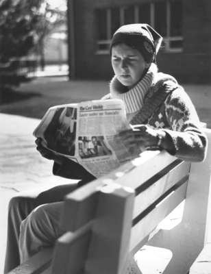 Woman sitting on a bench at Wilfrid Laurier University