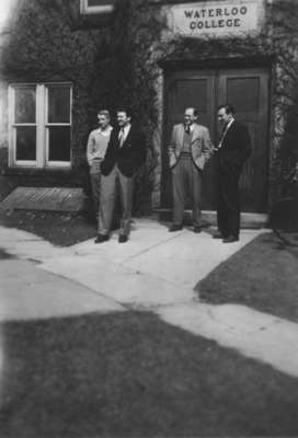 Four men standing in front of Willison Hall, Waterloo College