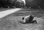 Man kneeling on lawn at Waterloo College