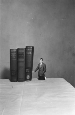 Waterloo College student with books