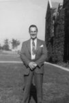 Man standing in front of Willison Hall, Waterloo College