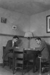 Two male Waterloo College students in men's common room