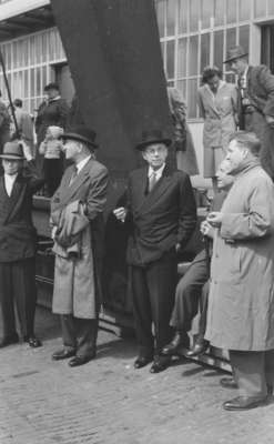 Five men standing in front of a building