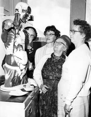 Four women looking at anatomical model