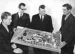 Four men with architectural model