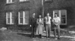 Four people standing in front of Willison Hall, Waterloo College