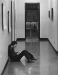 Waterloo Lutheran University student sitting in hallway