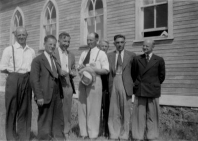 Group of men standing near a church