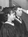 Two Waterloo Lutheran University students wearing academic gowns and hoods