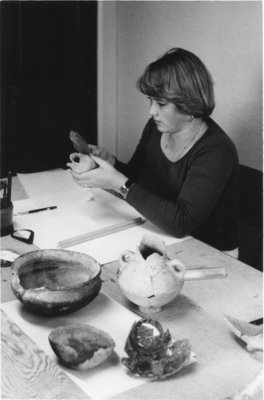 Woman working with archaeological tools