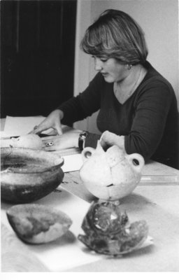 Woman working with archaeological tools