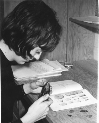 Waterloo Lutheran University student working with artifacts