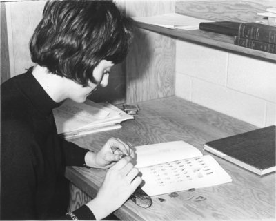 Waterloo Lutheran University student working with artifacts