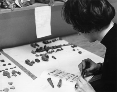 Waterloo Lutheran University student working with artifacts