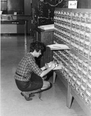 Woman using card catalogue in the Waterloo Lutheran University Library