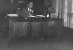 Erich Schultz seated at desk