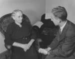 Wilfred Myra talking with an elderly woman