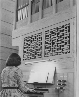 Woman playing organ in Keffer Memorial Chapel, Waterloo Lutheran Seminary