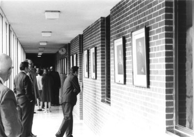 People viewing Waterloo Lutheran Seminary presidents portraits