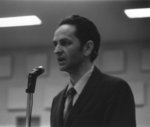 John Redekop speaking into a microphone