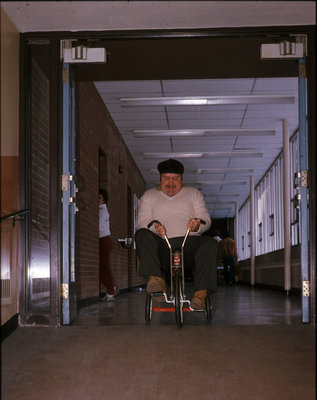 Tuffy Knight riding a tricycle at Winter Carnival, Wilfrid Laurier University