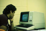 Man using computer terminal at Wilfrid Laurier University
