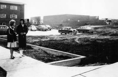 Two women standing near a construction site at Waterloo College