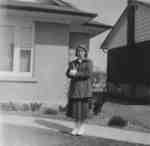 Waterloo College student Doreen Sanderson standing in front of a house