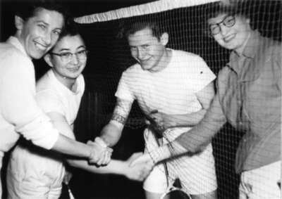 Four badminton players shaking hands